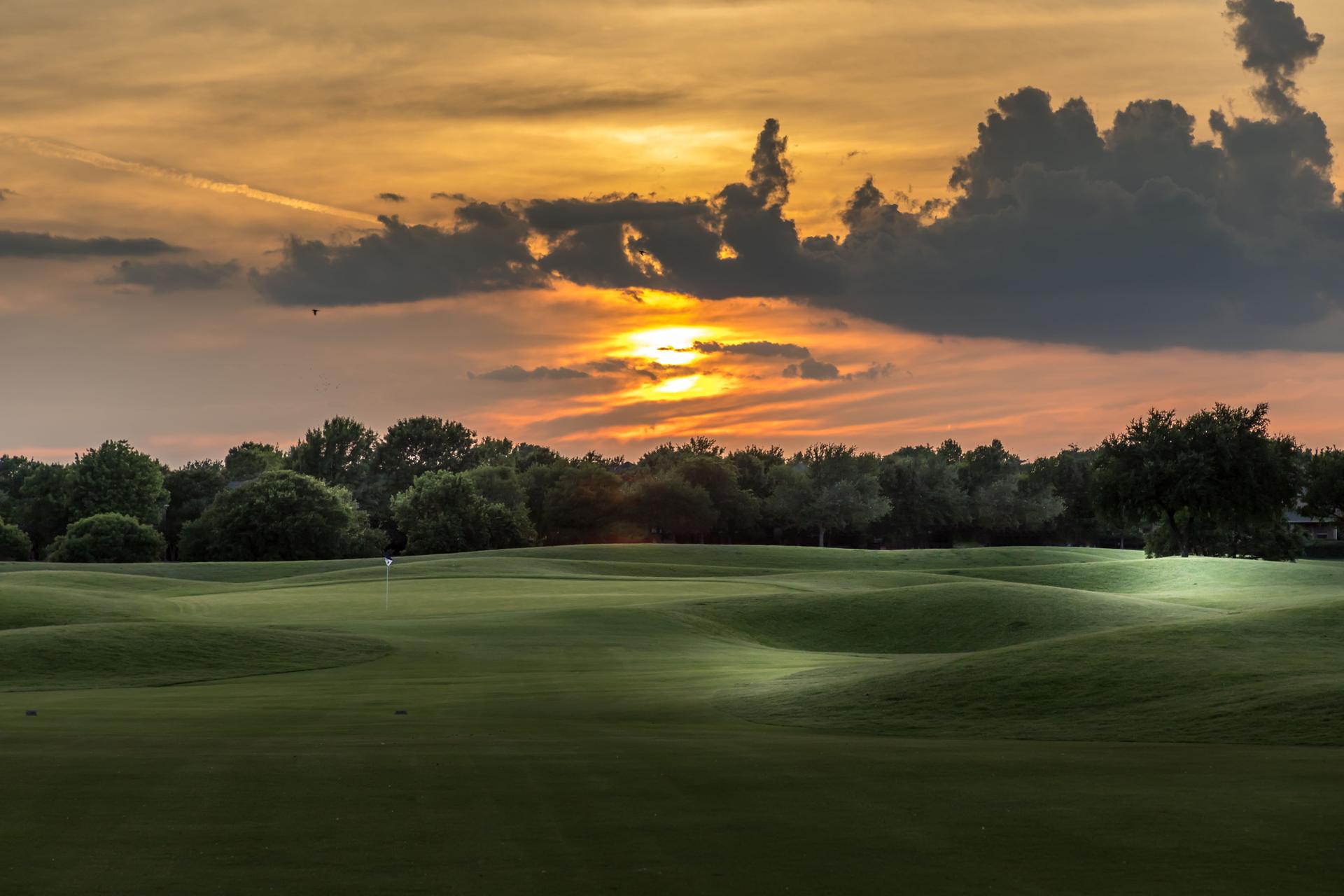 Scenic View Of A Golf Course Against Sky During Sunset
