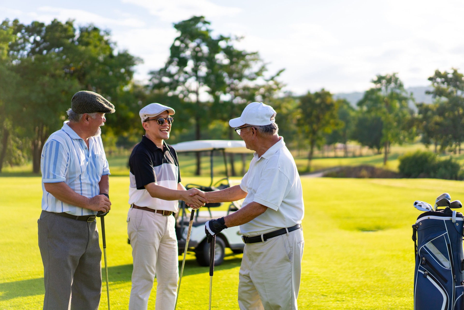 4K Group of Asian men golfer shaking hand after finish the game on golf course on summer vacation